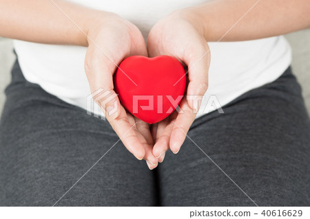 Happy pregnant woman holding love red heart shape. Happy pregnant woman holding love red heart shape. 40616629