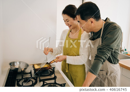 A Japanese middle-class couple standing in the kitchen A Japanese middle-class couple standing in the kitchen 40616745