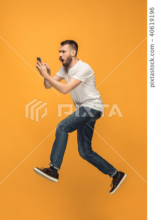 Full length of handsome young man taking selfie while jumping Full length of handsome young man taking selfie while jumping 40619196