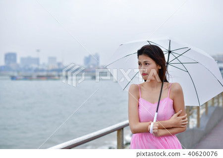 Holiday concept. Beautiful girl is holding umbrella on the beach Holiday concept. Beautiful girl is holding umbrella on the beach 40620076