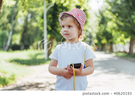 Cute girl listening to music with headphones outdoors 40620193