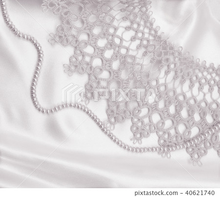 Smooth elegant golden silk or satin with pearls Smooth elegant golden silk or satin with pearls 40621740