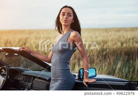 Beautiful woman near black convertible 40622976