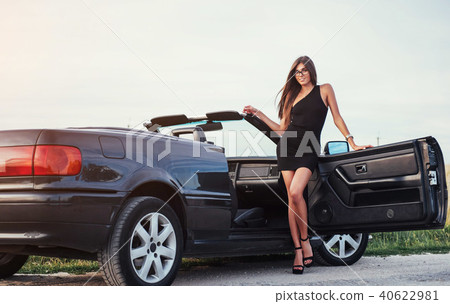 Beautiful woman near black convertible 40622981