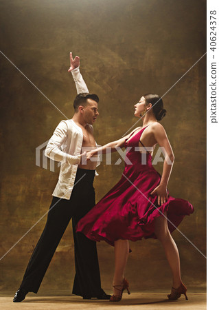 Dance ballroom couple in red dress dancing on studio background. Dance ballroom couple in red dress dancing on studio background. 40624378