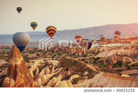Hot air balloon flying over rock landscape at Turkey. Cappadocia Hot air balloon flying over rock landscape at Turkey. Cappadocia 40625258