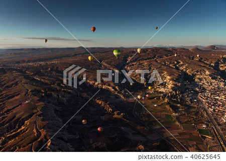 Hot air balloon flying over rock landscape at Cappadocia Turkey. Hot air balloon flying over rock landscape at Cappadocia Turkey. 40625645