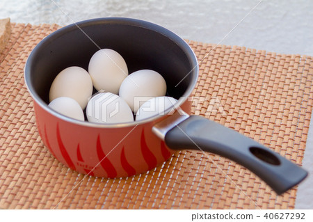 a few boiled eggs in a saucepan in the sun a few boiled eggs in a saucepan in the sun 40627292