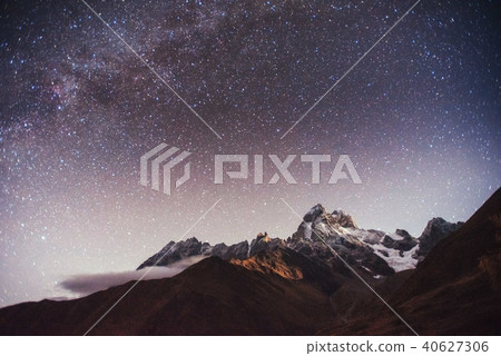 Fantastic starry sky. Autumn landscape and snow-capped peaks 40627306