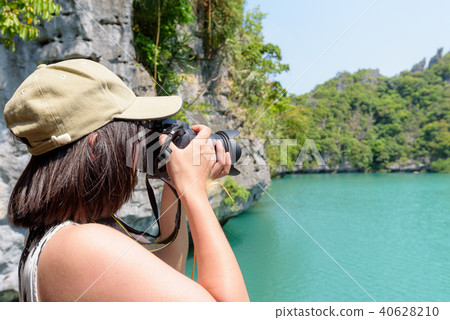Woman tourist taking photos Thale Nai 40628210