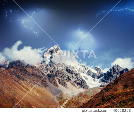 Fantastic collage. Beautiful lightning over the snow-capped moun Fantastic collage. Beautiful lightning over the snow-capped moun 40628298