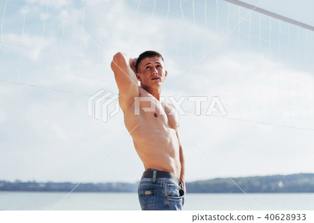 muscular male model with perfect body posing in blue jeans 40628933