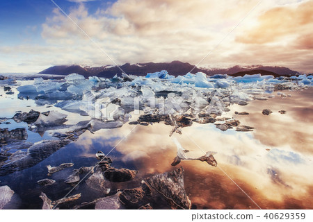 Icebergs in the glacial lake with a mountain 40629359