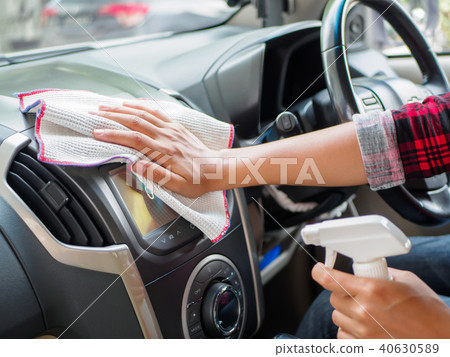Hand cleaning interior car with microfiber cloth 40630589