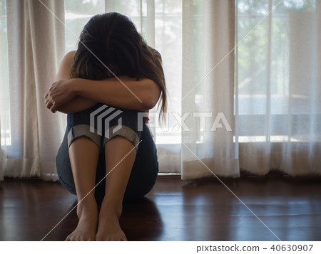 Sad and despaired woman hug her knee and cry 40630907