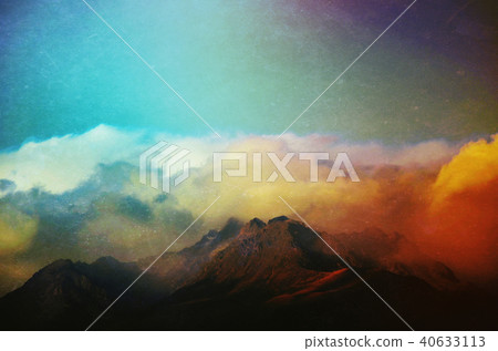 Clouds rolling over mountain peaks Clouds rolling over mountain peaks 40633113