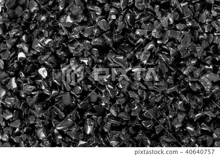 Black small dry pebbles as background. 40640757
