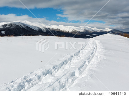 Sledge trace and footprints winter mountain hill 40641340