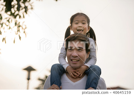 Asian girl on neck parents big happy laughing. 40645159