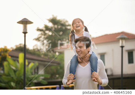 Asian girl on neck parents big happy laughing. 40645160