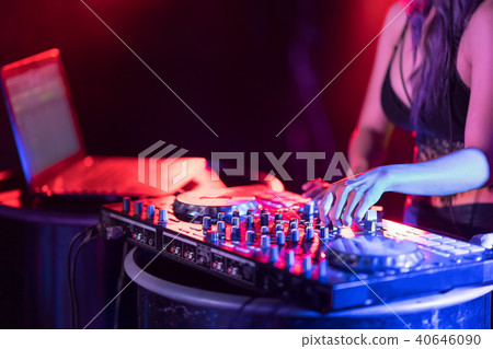 Motionblur of Dj hands on equipment deck and mixer 40646090