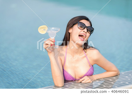 Sexy woman in swimming pool and holding cocktail. Sexy woman in swimming pool and holding cocktail. 40646091
