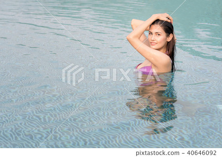 Asian sexy woman in bikini in swimming pool. Asian sexy woman in bikini in swimming pool. 40646092