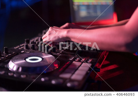 Motionblur of Dj hands on equipment deck and mixer Motionblur of Dj hands on equipment deck and mixer 40646093