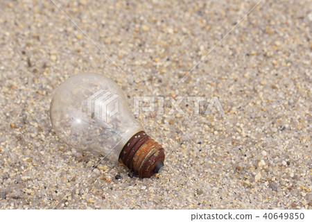 electric light bulb on sand electric light bulb on sand 40649850