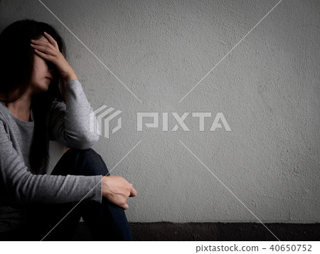 Depressed broken hearted woman sitting alone 40650752