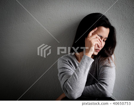 Depressed broken hearted woman sitting alone 40650753