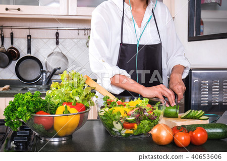Young happiness Woman Cooking vegetables salad in the kitchen, H Young happiness Woman Cooking vegetables salad in the kitchen, H 40653606