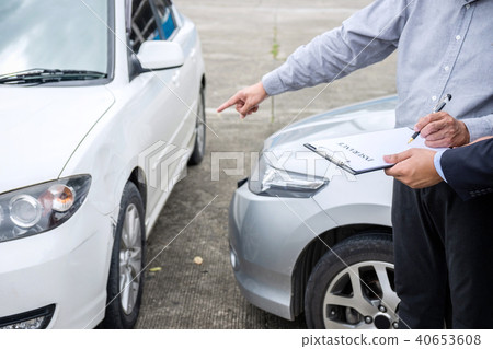 Insurance Agent examine Damaged Car and filing Report Claim Form Insurance Agent examine Damaged Car and filing Report Claim Form 40653608