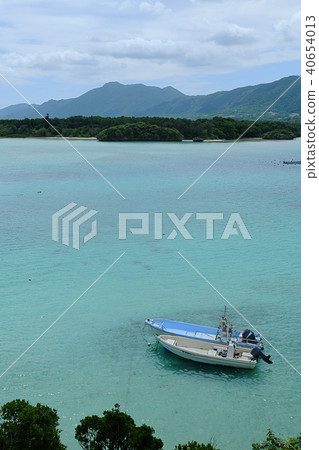 The boat is parked in calm water The boat is parked in calm water 40654013