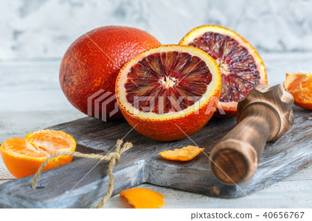 Whole and halves of blood orange and citrus press. Whole and halves of blood orange and citrus press. 40656767