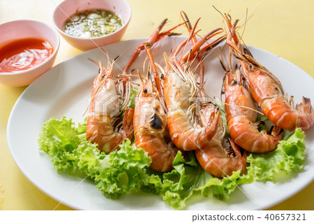 Thai food: Shrimp grilled with spicy seafood sauce, on yellow table, stall Thai food: Shrimp grilled with spicy seafood sauce, on yellow table, stall 40657321