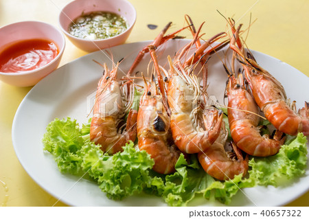 Thai food: Shrimp grilled with spicy seafood sauce, on yellow table, stall Thai food: Shrimp grilled with spicy seafood sauce, on yellow table, stall 40657322