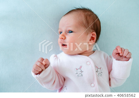 Emotional baby lying in cradle Emotional baby lying in cradle 40658562