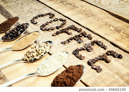 spoons with coffee and an inscription on an old wooden table spoons with coffee and an inscription on an old wooden table 40660180
