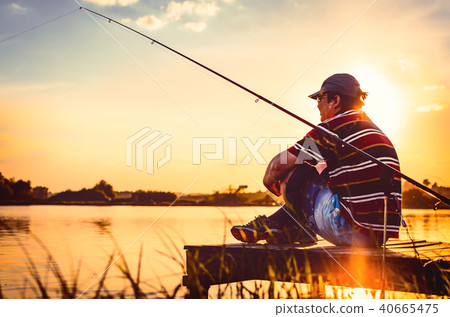 Fisherman caught fish. Caucasian man catch fish on lake. Angler on river fishing. fishing rod lake Fisherman caught fish. Caucasian man catch fish on lake. Angler on river fishing. fishing rod lake 40665475