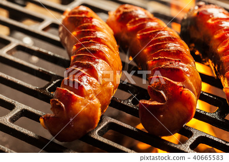 Grilling sausages on barbecue grill 40665583