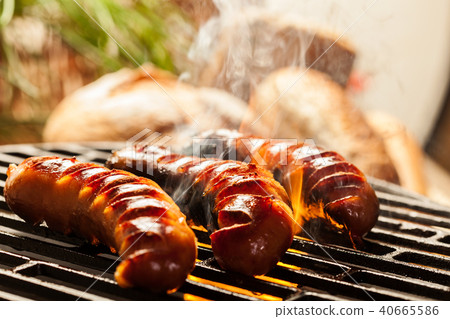 Grilling sausages on barbecue grill Grilling sausages on barbecue grill 40665586