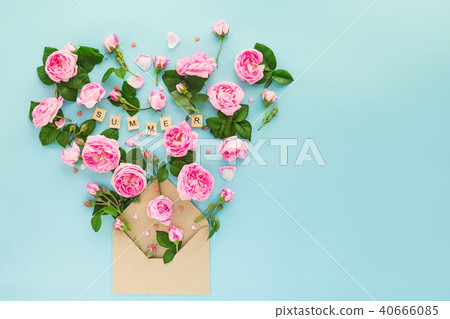 Close up reative layout with pink tea rose flowers, green leaves, candy hearts fly out of craft Close up reative layout with pink tea rose flowers, green leaves, candy hearts fly out of craft 40666085