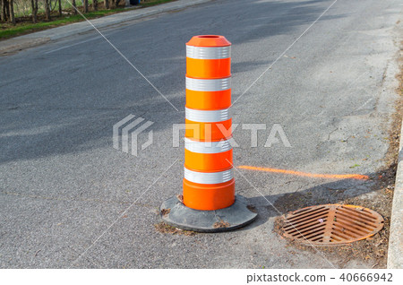The orange traffic cone on the sidewalk in Montrea 40666942