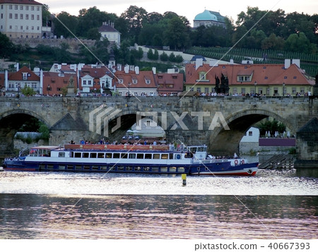 Prague river tourist boat go under bridge 40667393