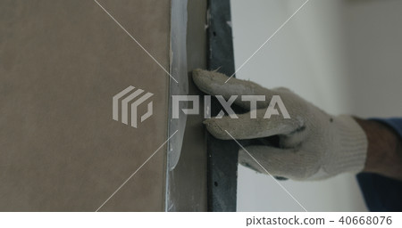 worker applying putty on the wall with copy space 40668076