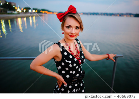 A beautiful young woman dressed stand  40669072