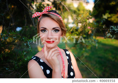 young beautiful caucasian woman posing in a dress 40669358