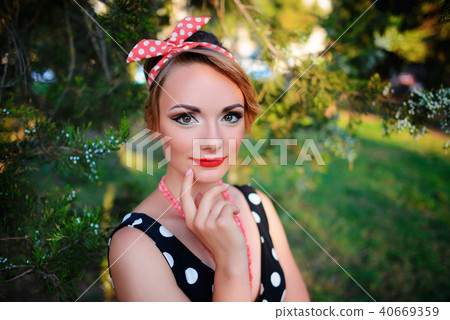 young beautiful caucasian woman posing in a dress 40669359