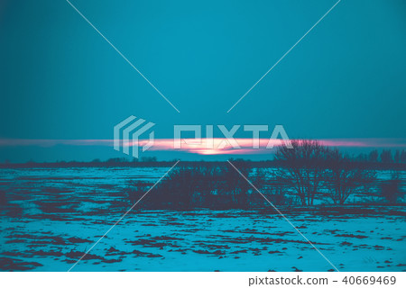 Natural Sunset Sunrise Over Field Or Meadow. Bright Dramatic Sky And Dark Ground. Countryside Natural Sunset Sunrise Over Field Or Meadow. Bright Dramatic Sky And Dark Ground. Countryside 40669469